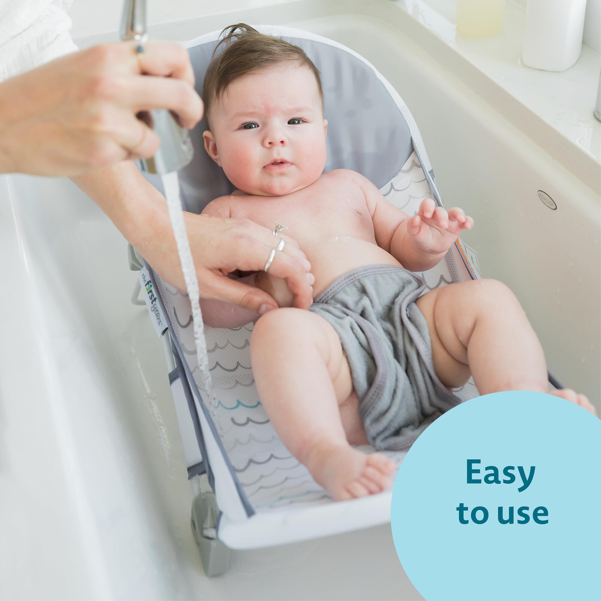 The First Years Sure Comfort Folding Baby Bather - Baby to Toddler Bath Tub - No-Slip Seat - for Sink or Tub Use